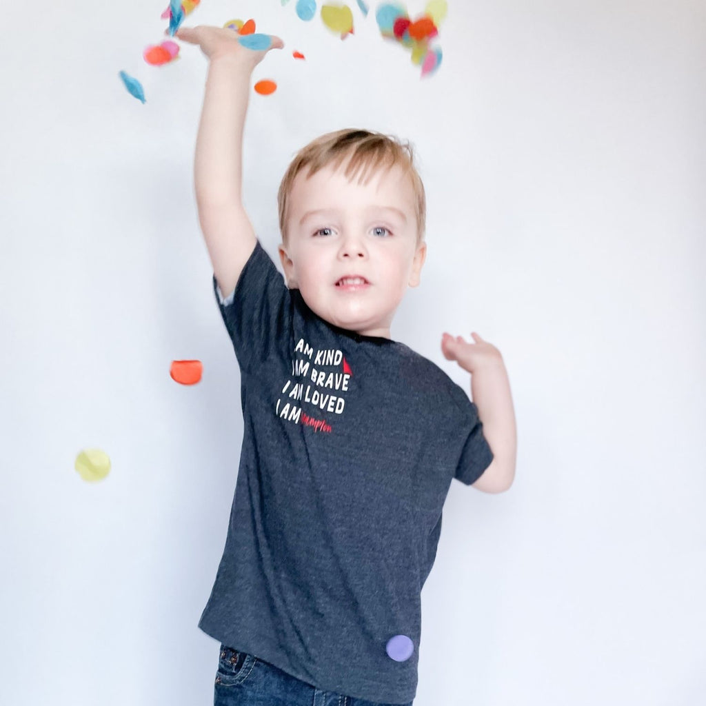 A picture of a little boy throwing confetti in the air. It's important that we instill confidence and nurture virtues that will help them throughout their life.   