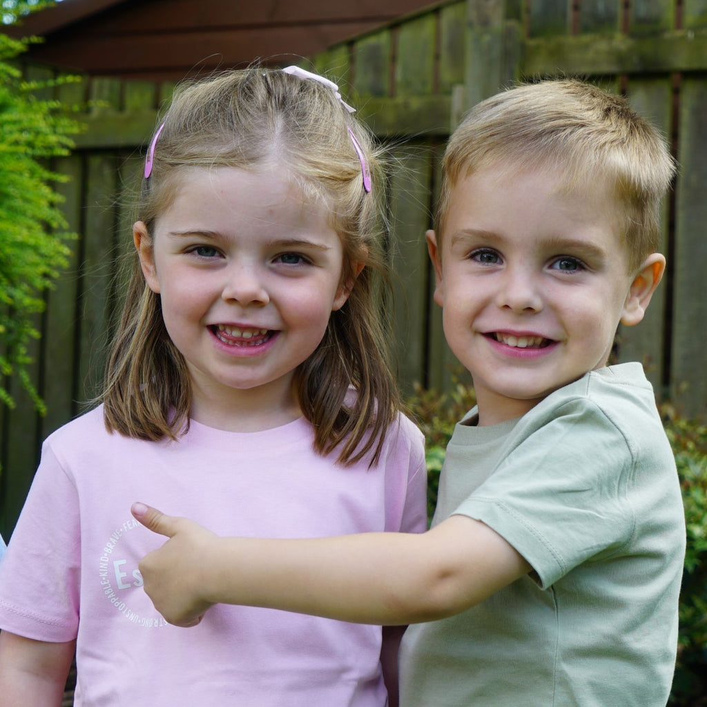 Personalized affirmation t-shirts for kids, including words like "fearless", "smart", "loved", "creative", "fun", "strong"