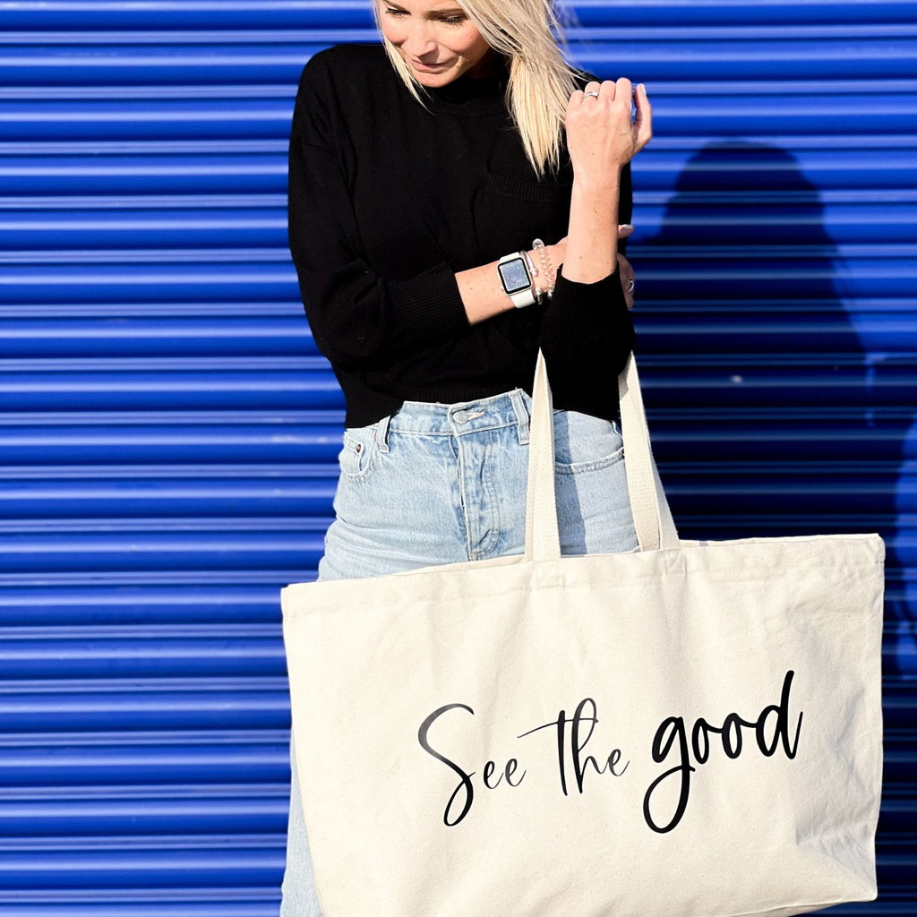 Oversized tote in a thick durable canvas which says "See the good". These totes come in 4 different text options, two text colors and 4 tote color options. 