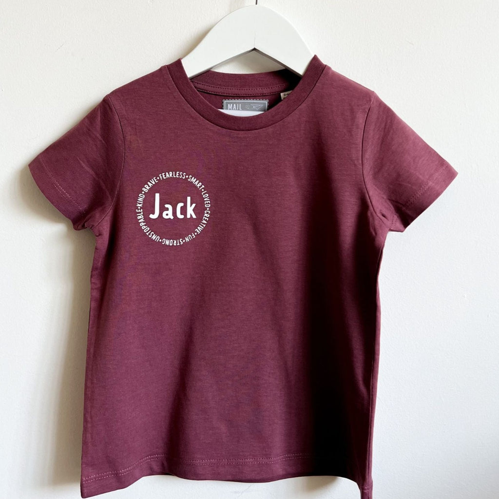Personalized affirmation t-shirts for kids, including words like "fearless", "smart", "loved", "creative", "fun", "strong"