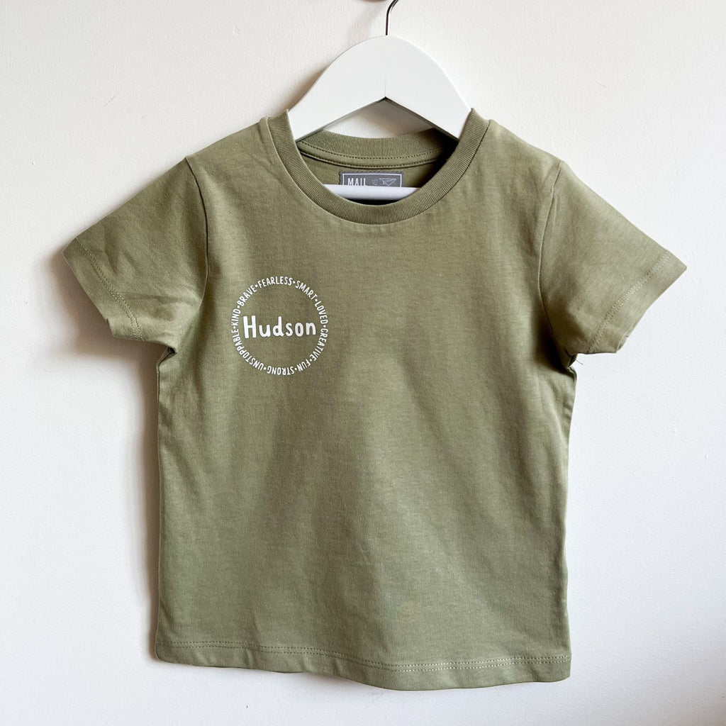 Personalized affirmation t-shirts for kids, including words like "fearless", "smart", "loved", "creative", "fun", "strong"