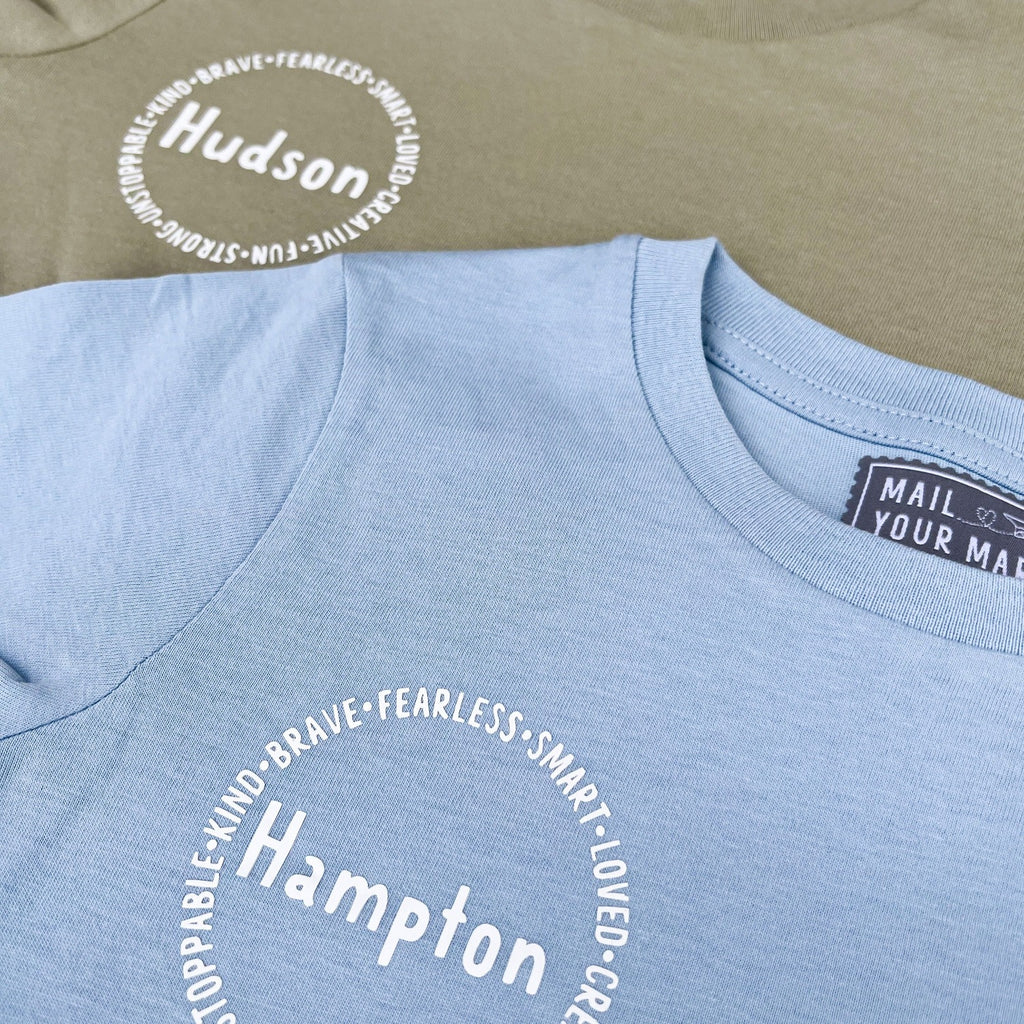 Personalized affirmation t-shirts for kids, including words like "fearless", "smart", "loved", "creative", "fun", "strong"