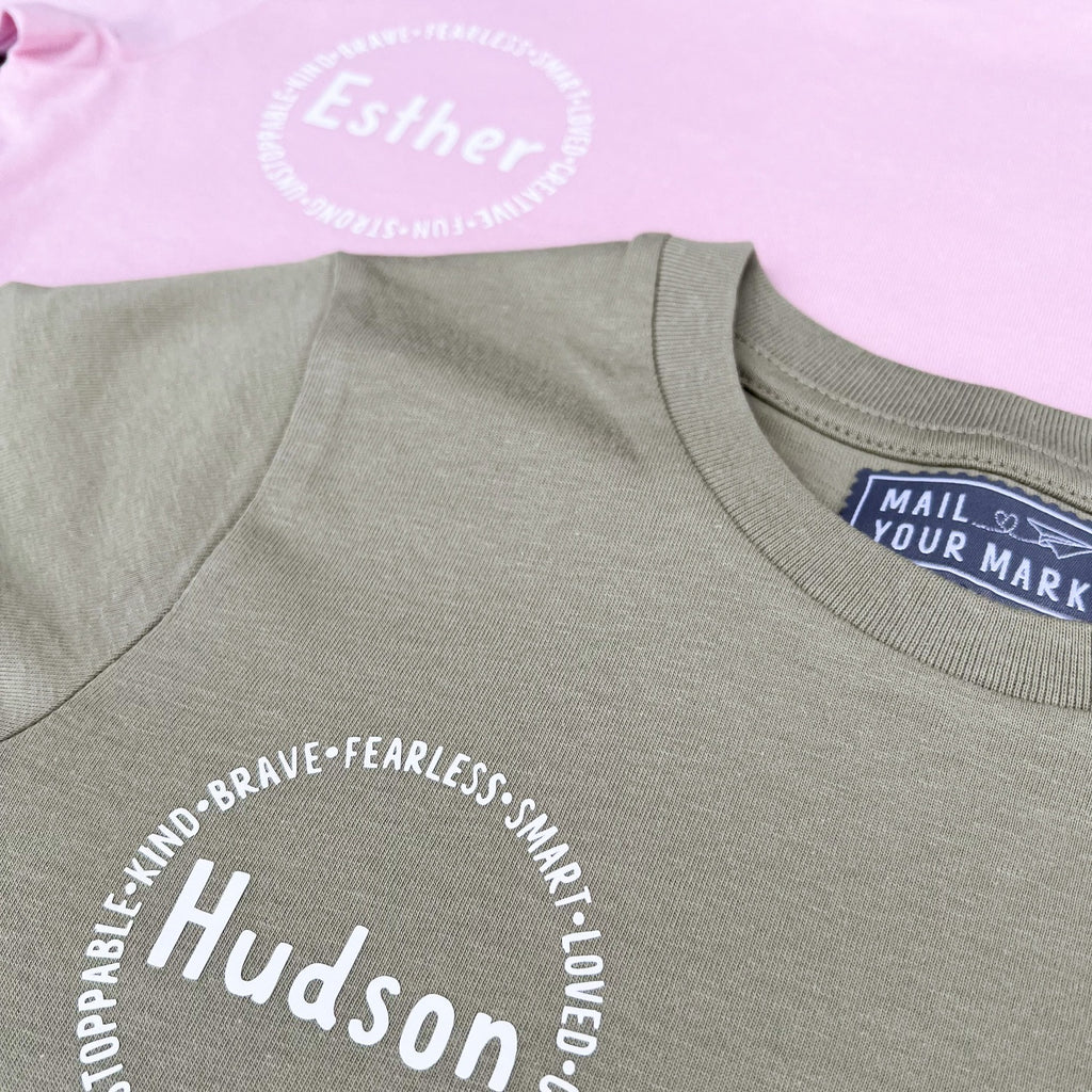 Personalized affirmation t-shirts for kids, including words like "fearless", "smart", "loved", "creative", "fun", "strong"