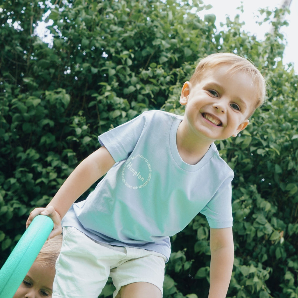 Kids boy affirmation t-shirt with words like "fearless", "smart", "loved", "creative", "fun", "strong"